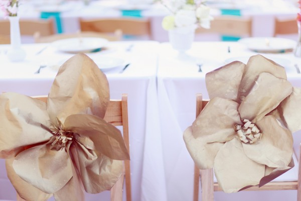 Giant-Gold-Paper-Flowers-on-Reception-Chairs-600x400